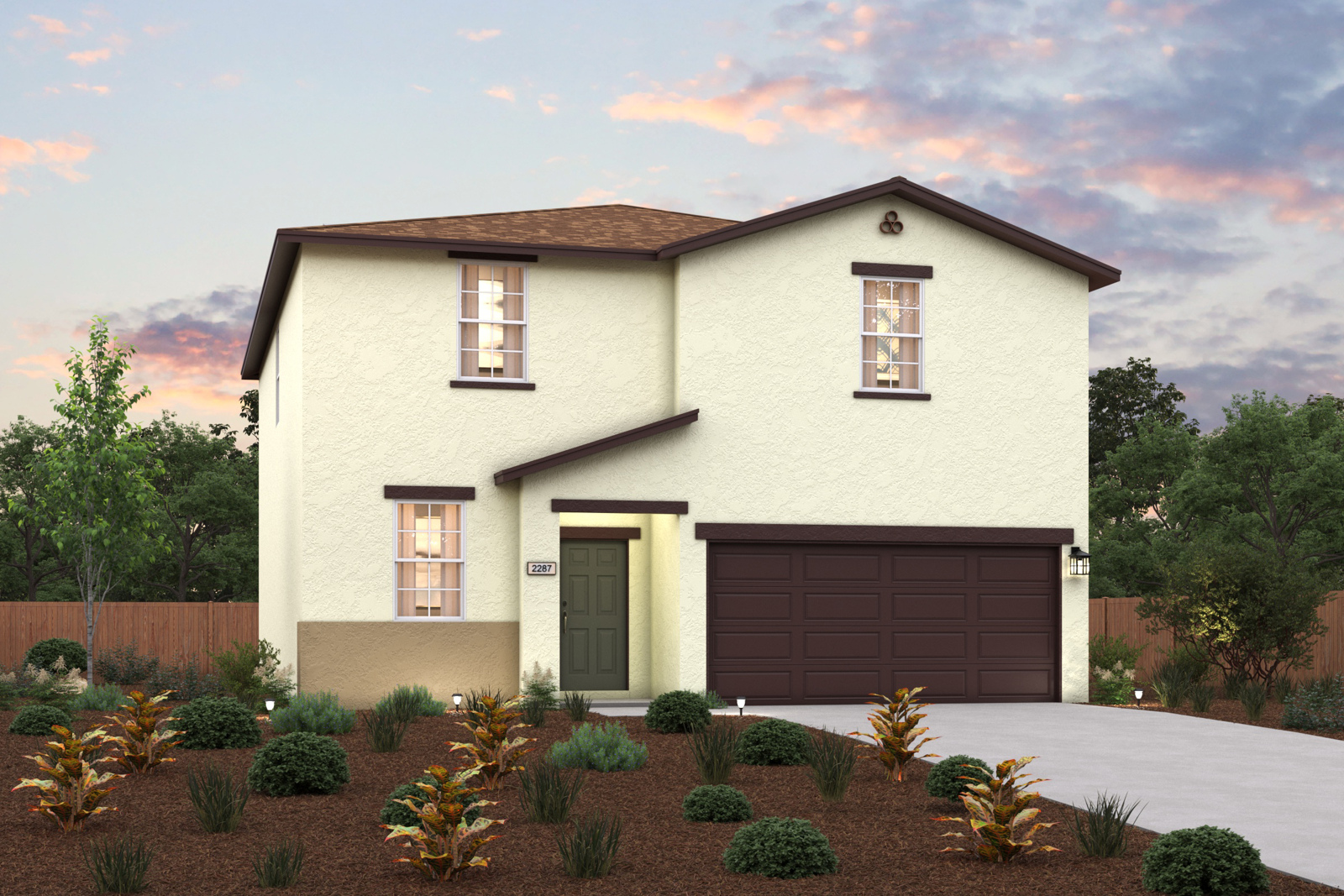 A house with a garage and bushes in front of it.