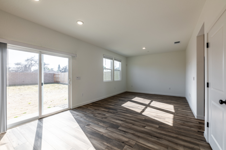 A room with a wood floor and windows.
