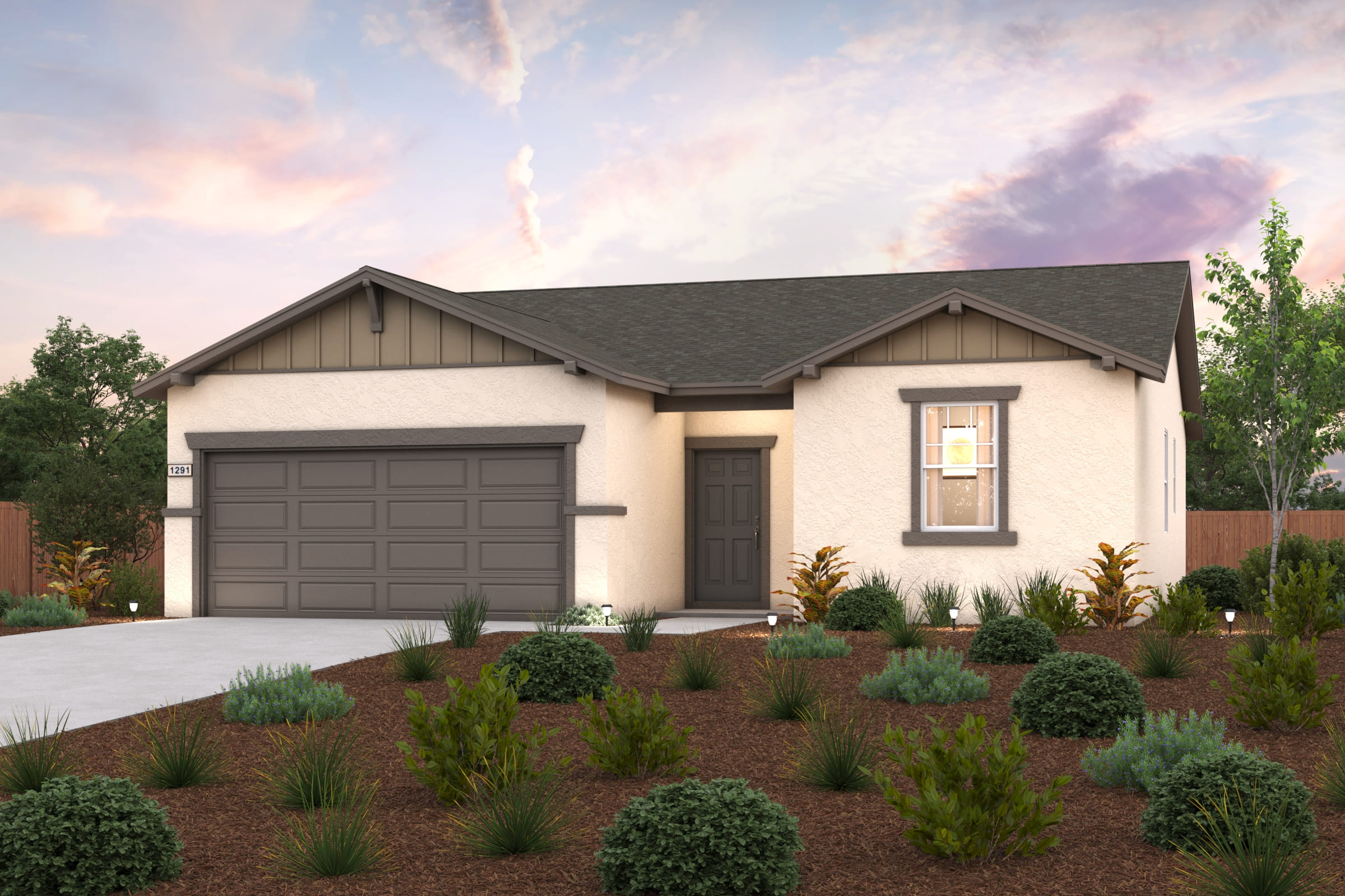 A house with a garage and bushes in front of it.