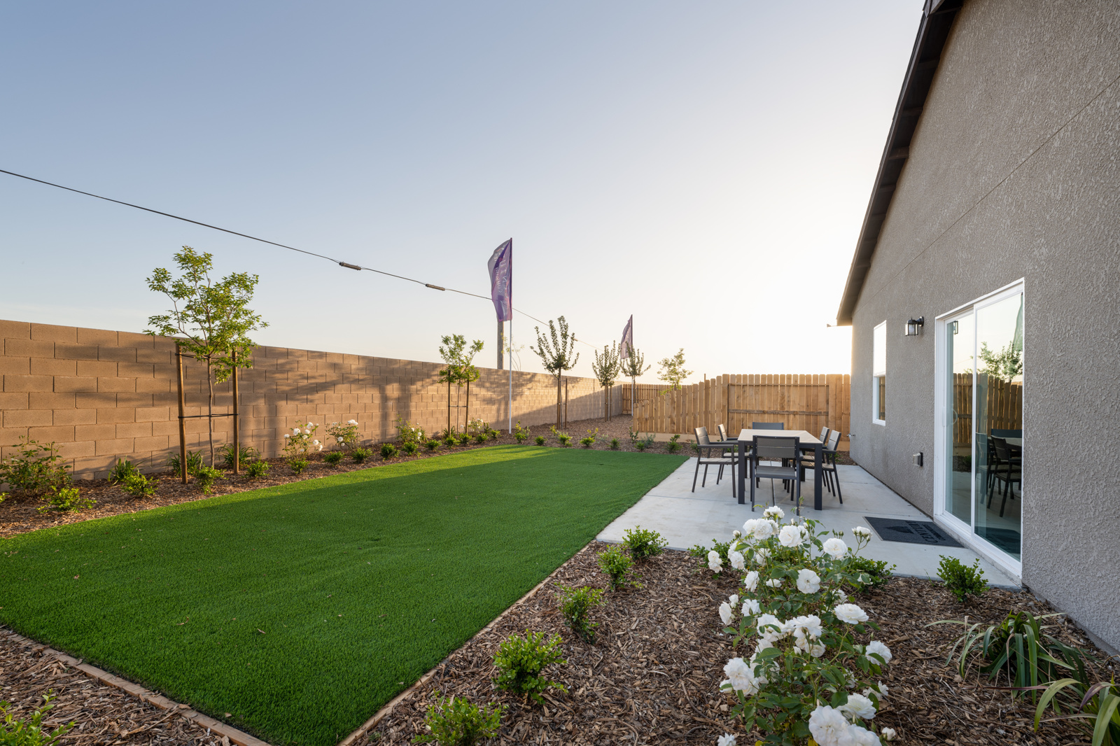 A backyard with a pool and a building.