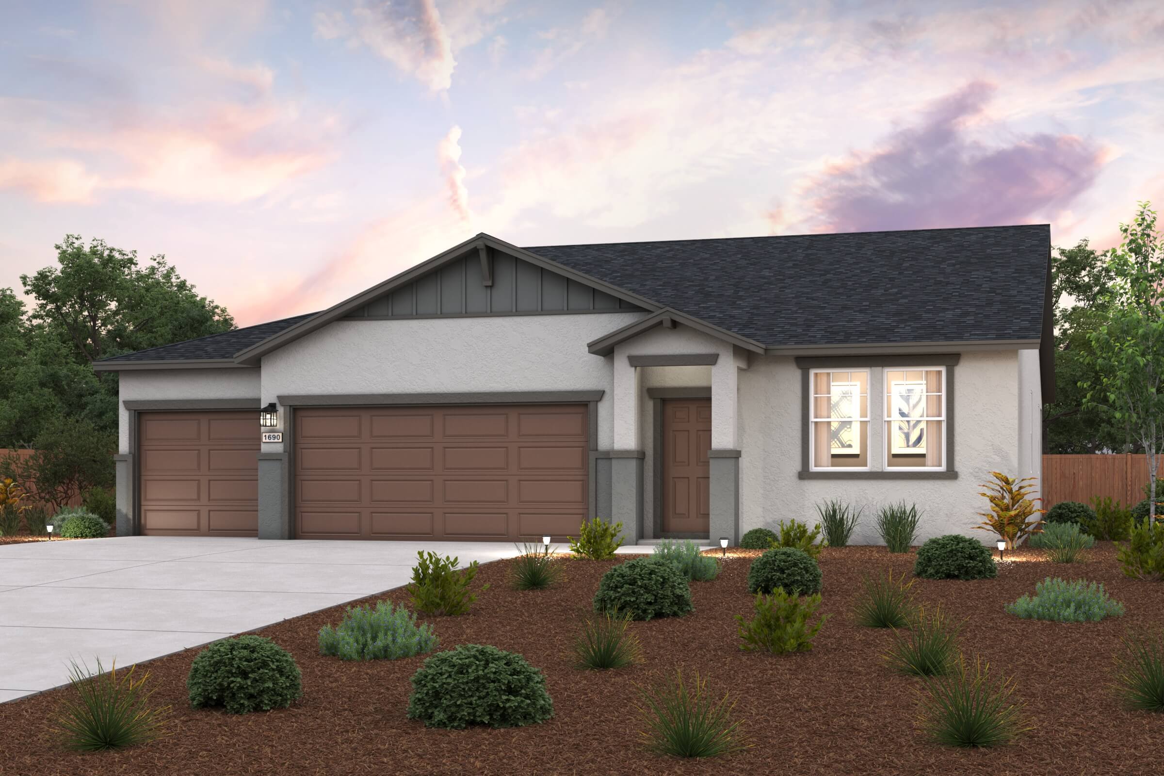 A house with a garage and bushes.