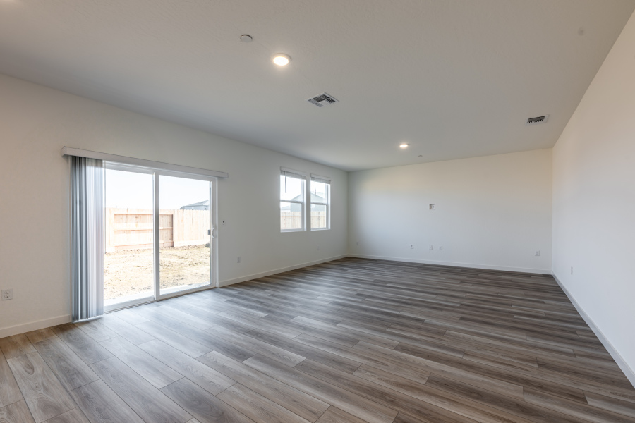 A room with a wood floor and windows.
