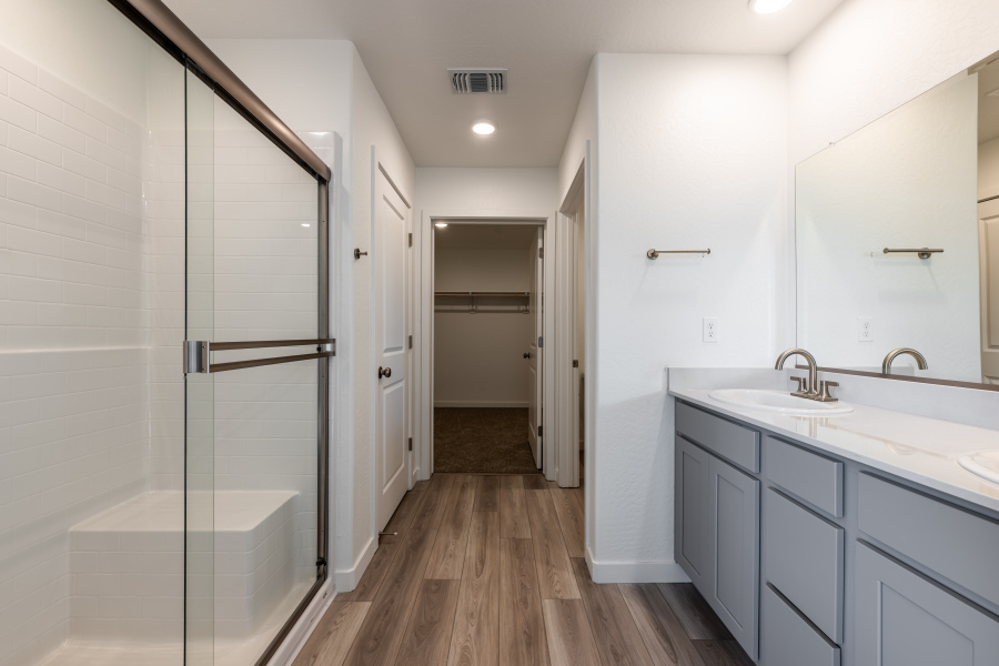A bathroom with white cabinets.