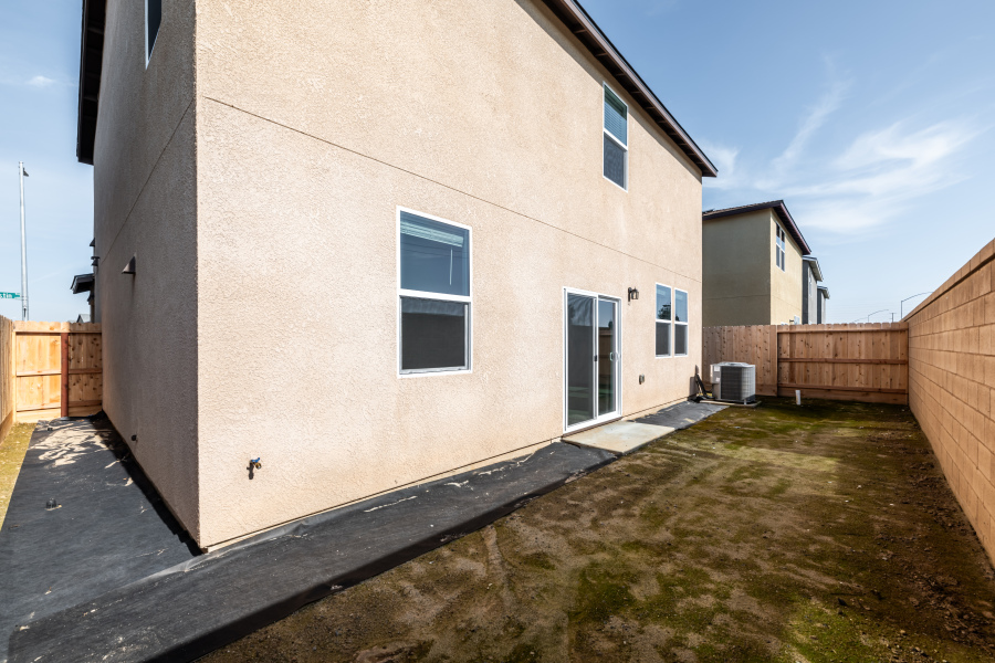 A white building with a fence around it.