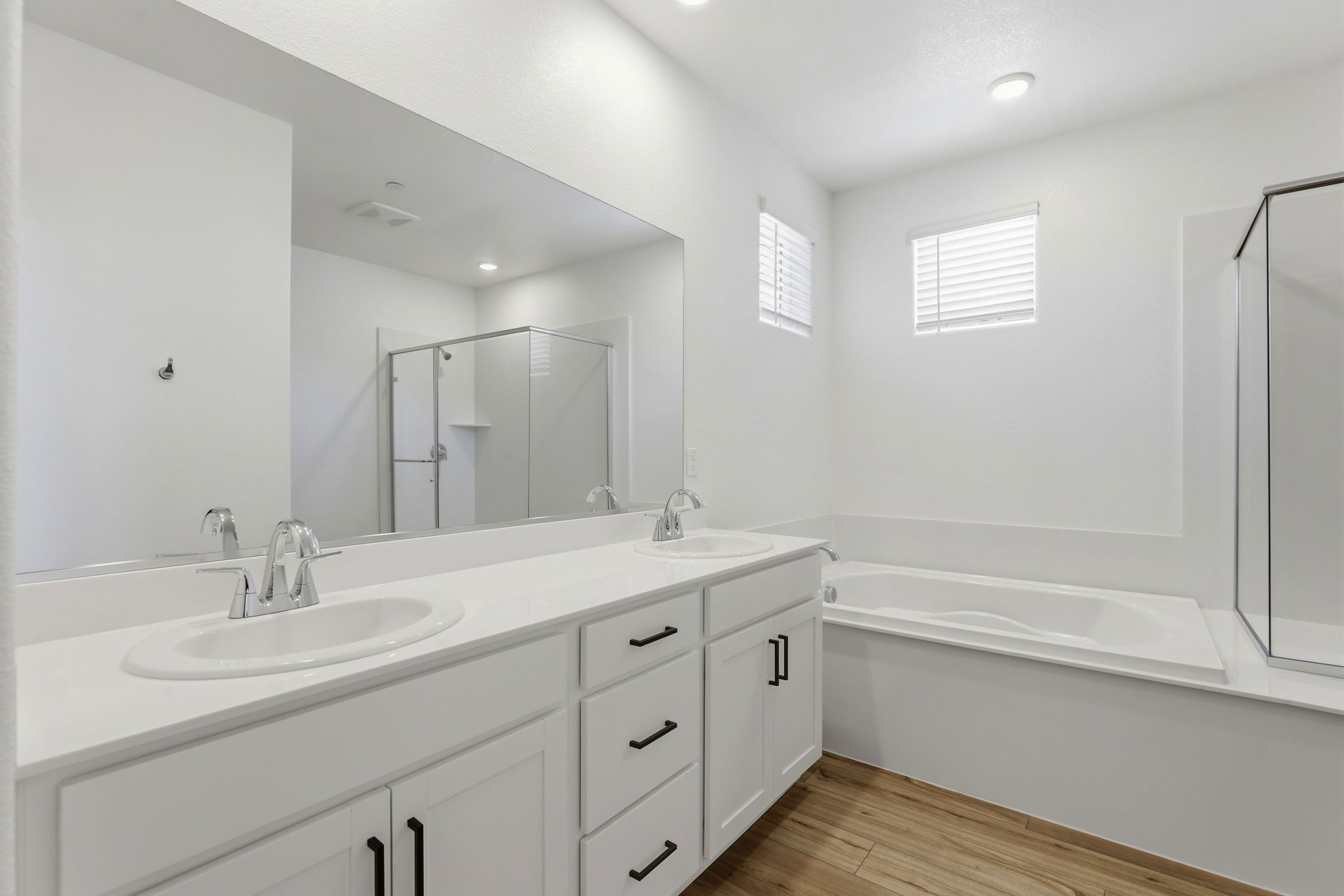 A bathroom with a large mirror.