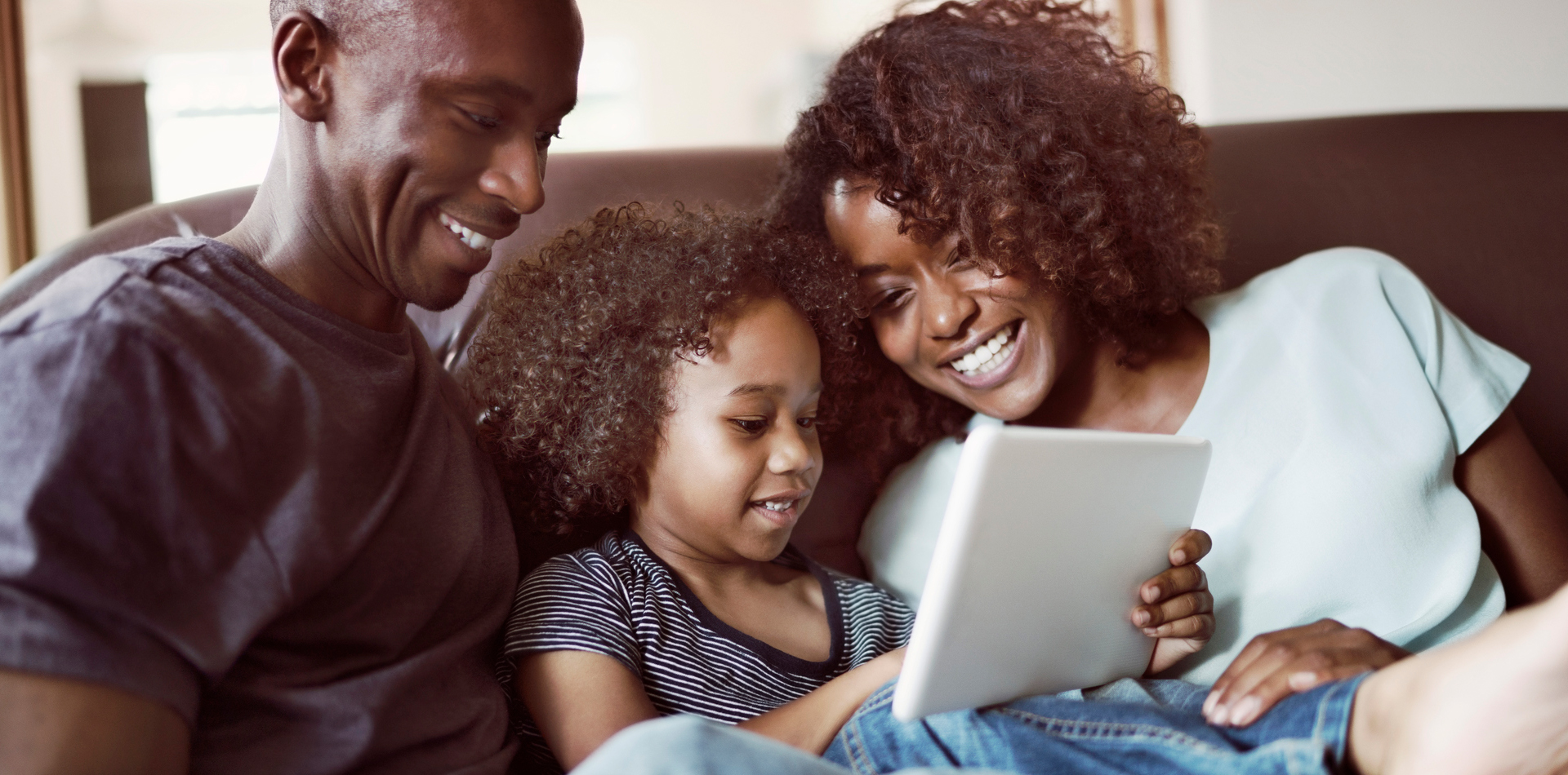 A family looking at a tablet.