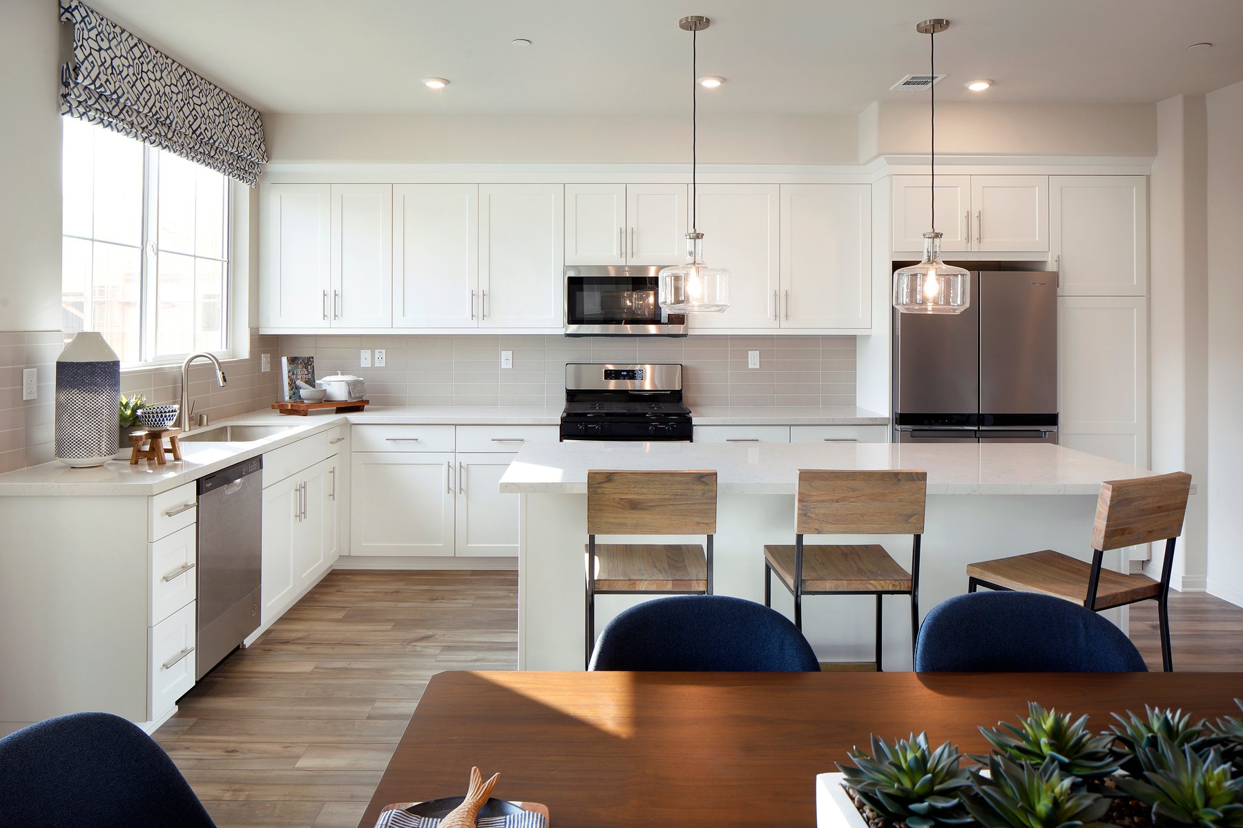 A kitchen with white cabinets.