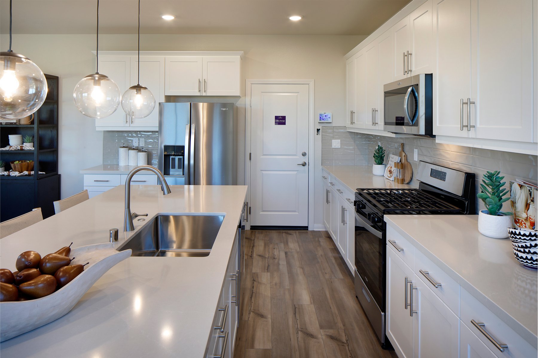 A kitchen with white cabinets.