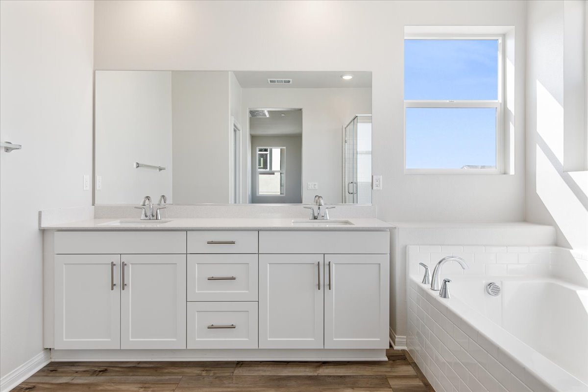 A bathroom with white cabinets.