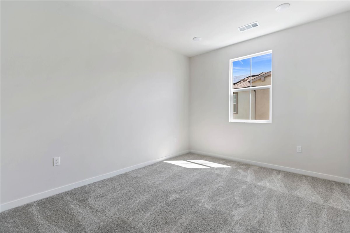 A room with a window and a carpet.