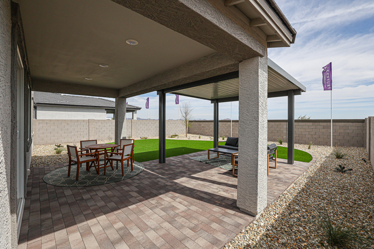 A patio with a table and chairs.