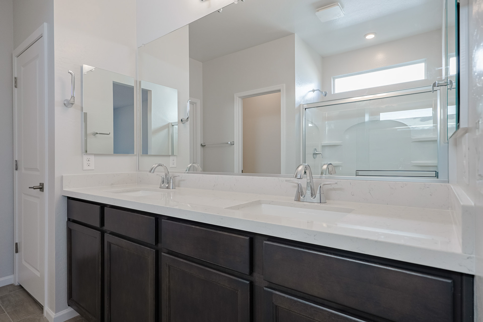 A bathroom with a large mirror.