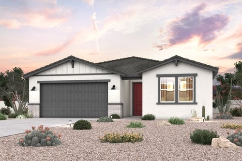 A house with a garage and bushes.