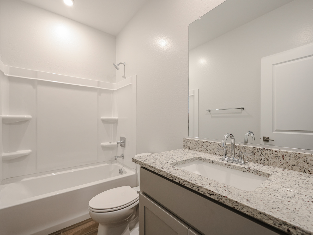 A bathroom with a marble countertop.