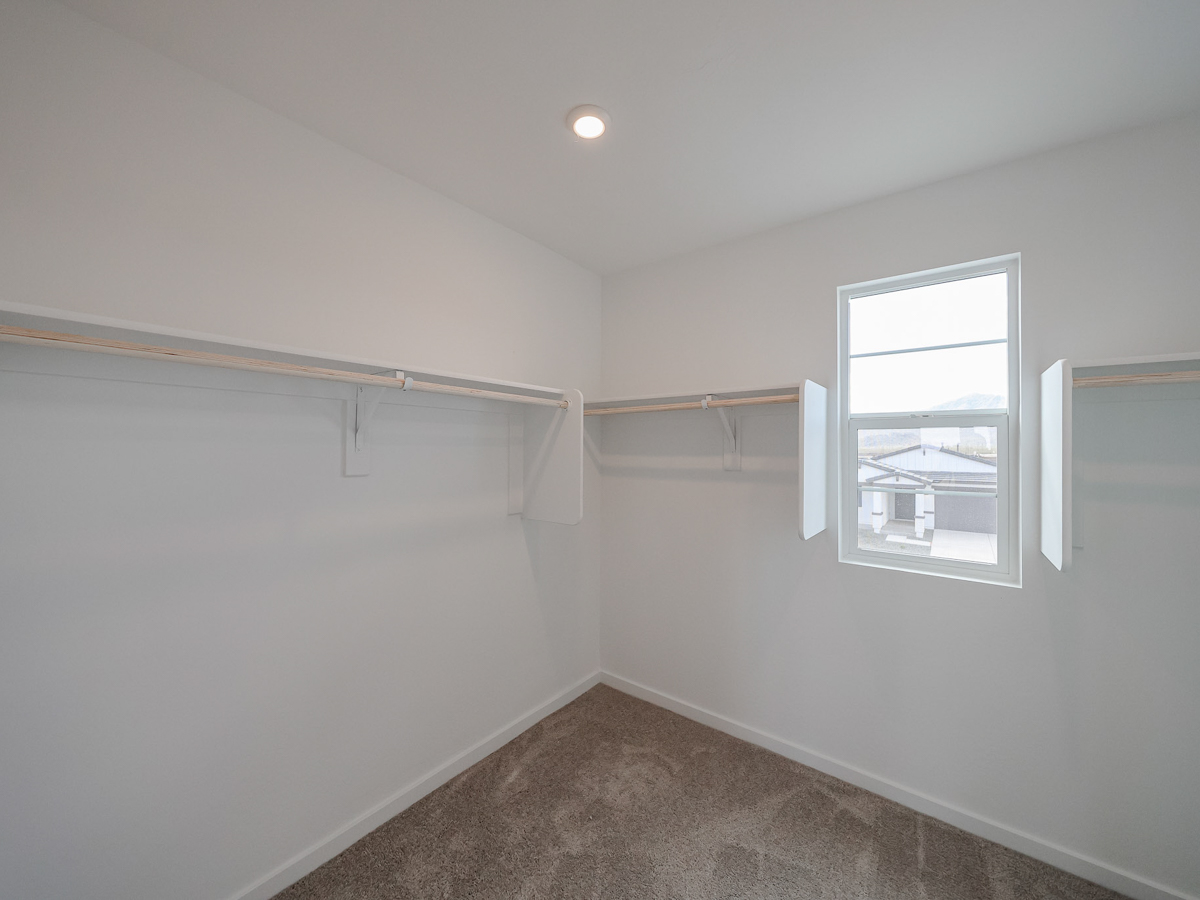 A room with a window and a carpet.