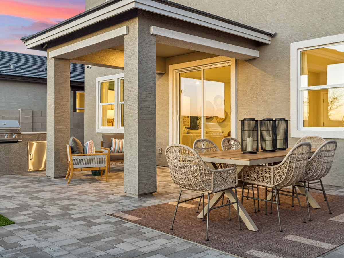 A patio with a table and chairs.