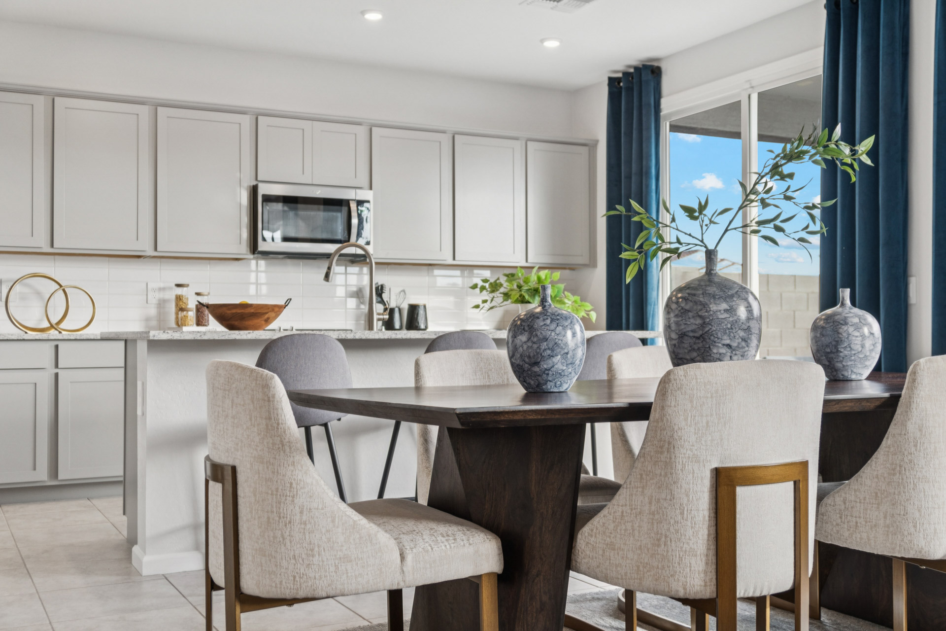 A kitchen with a table and chairs.