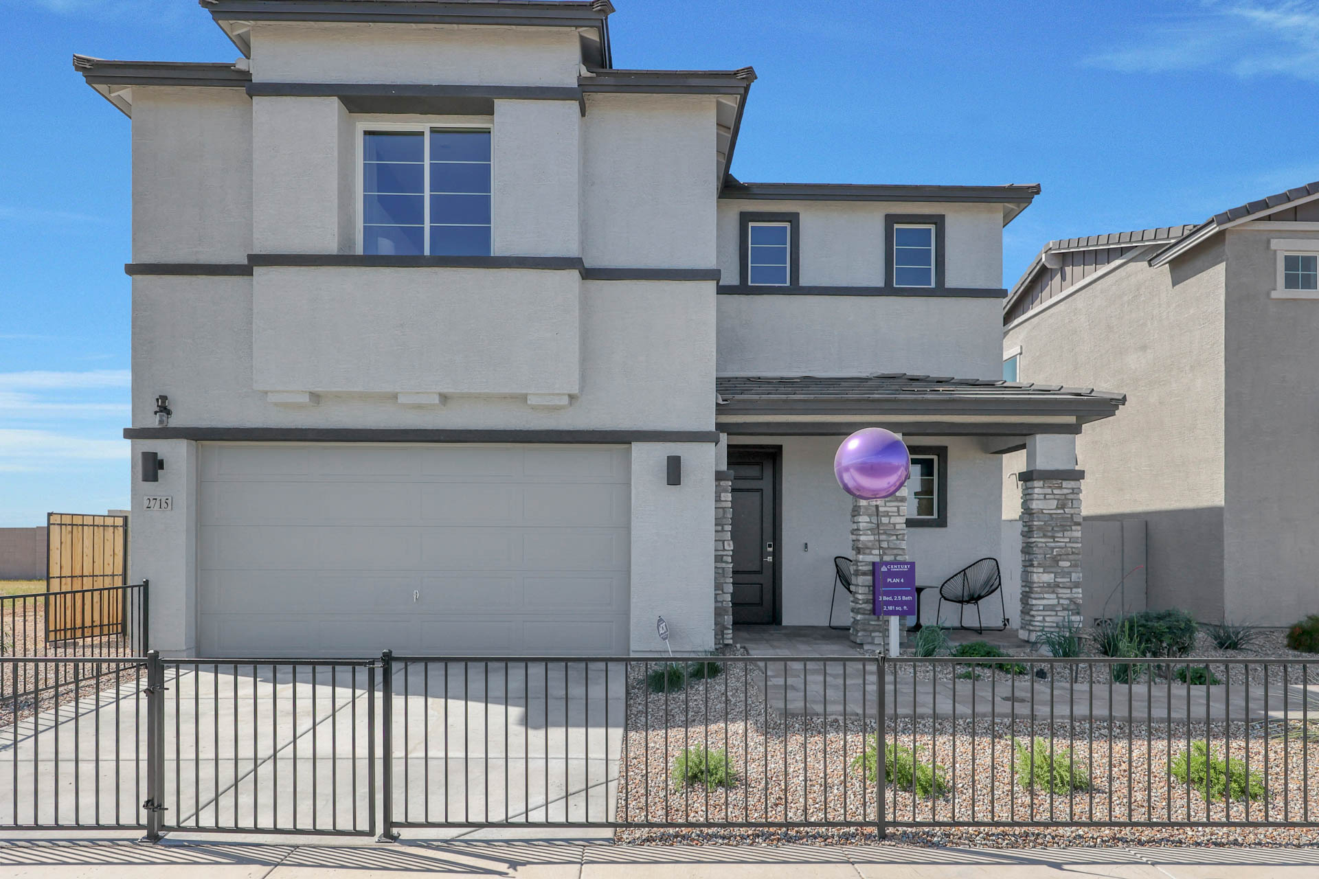 A white building with a fence.