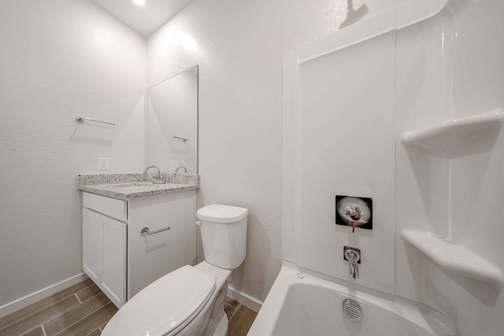 A bathroom with a tub toilet and sink.