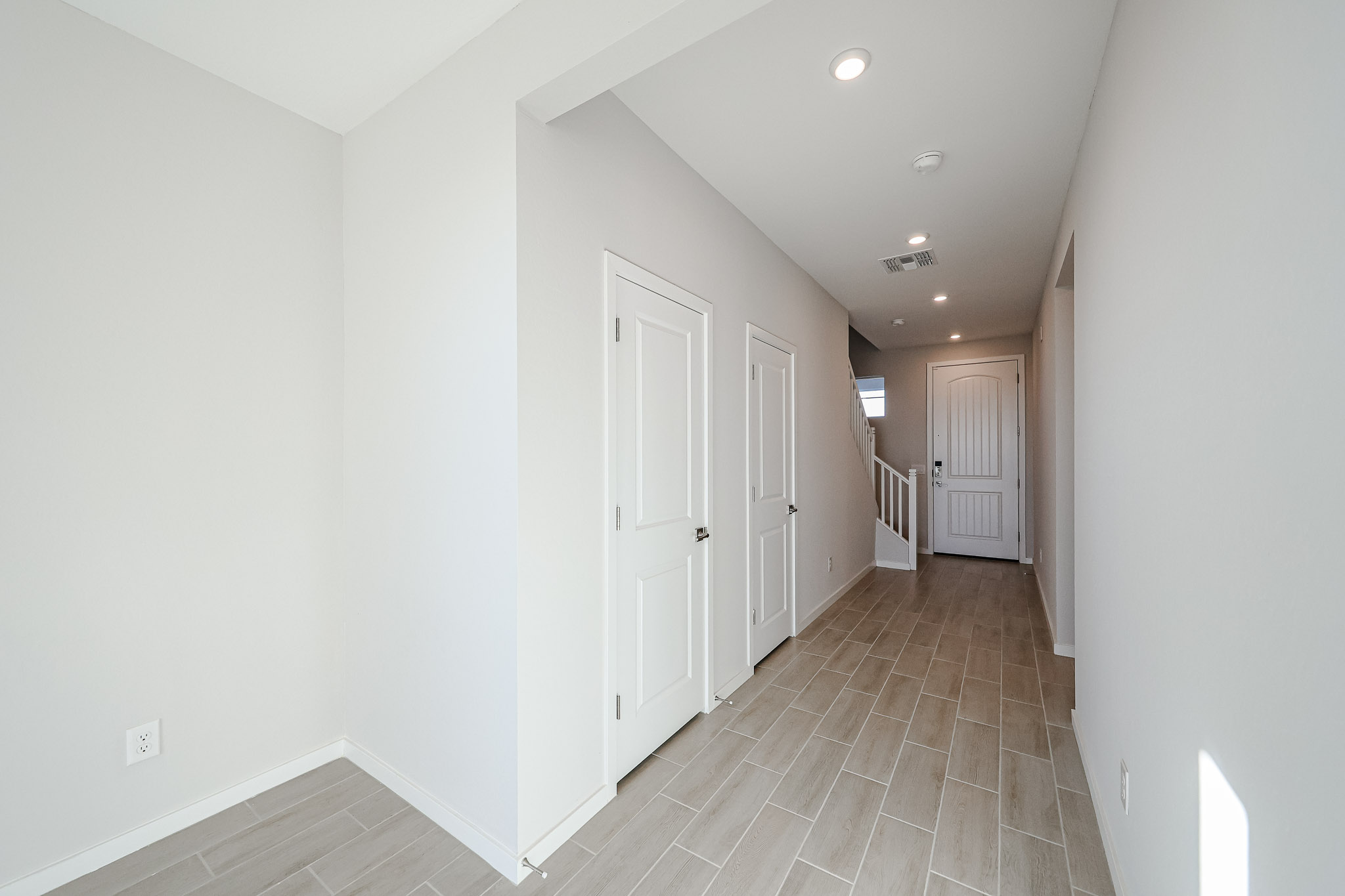 A hallway with white doors.
