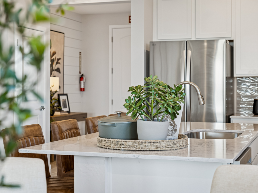A kitchen with a table and chairs.