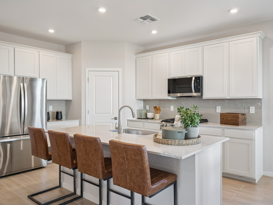 A kitchen with white cabinets.