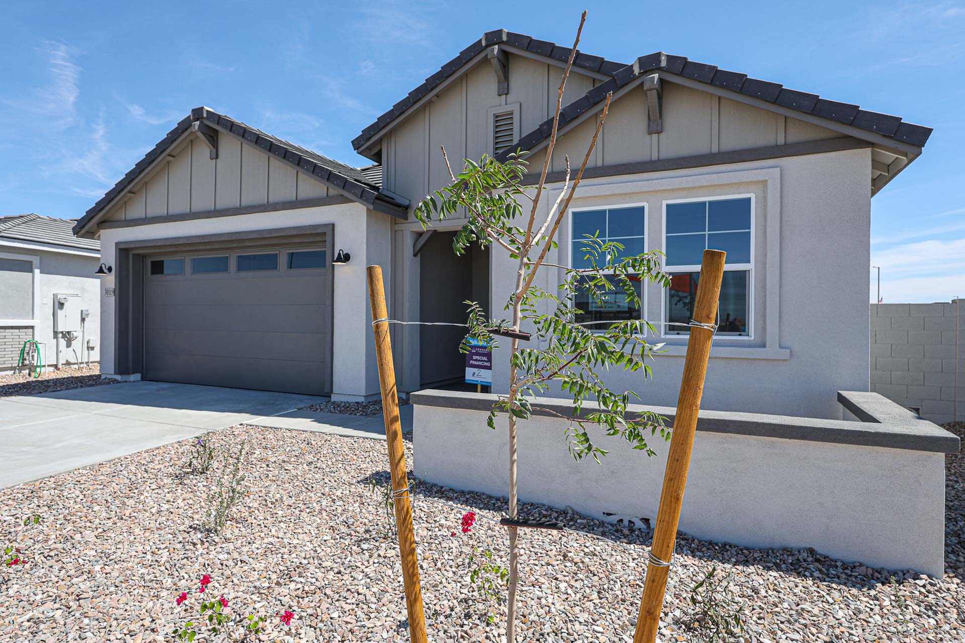 A house with a tree in the front yard.