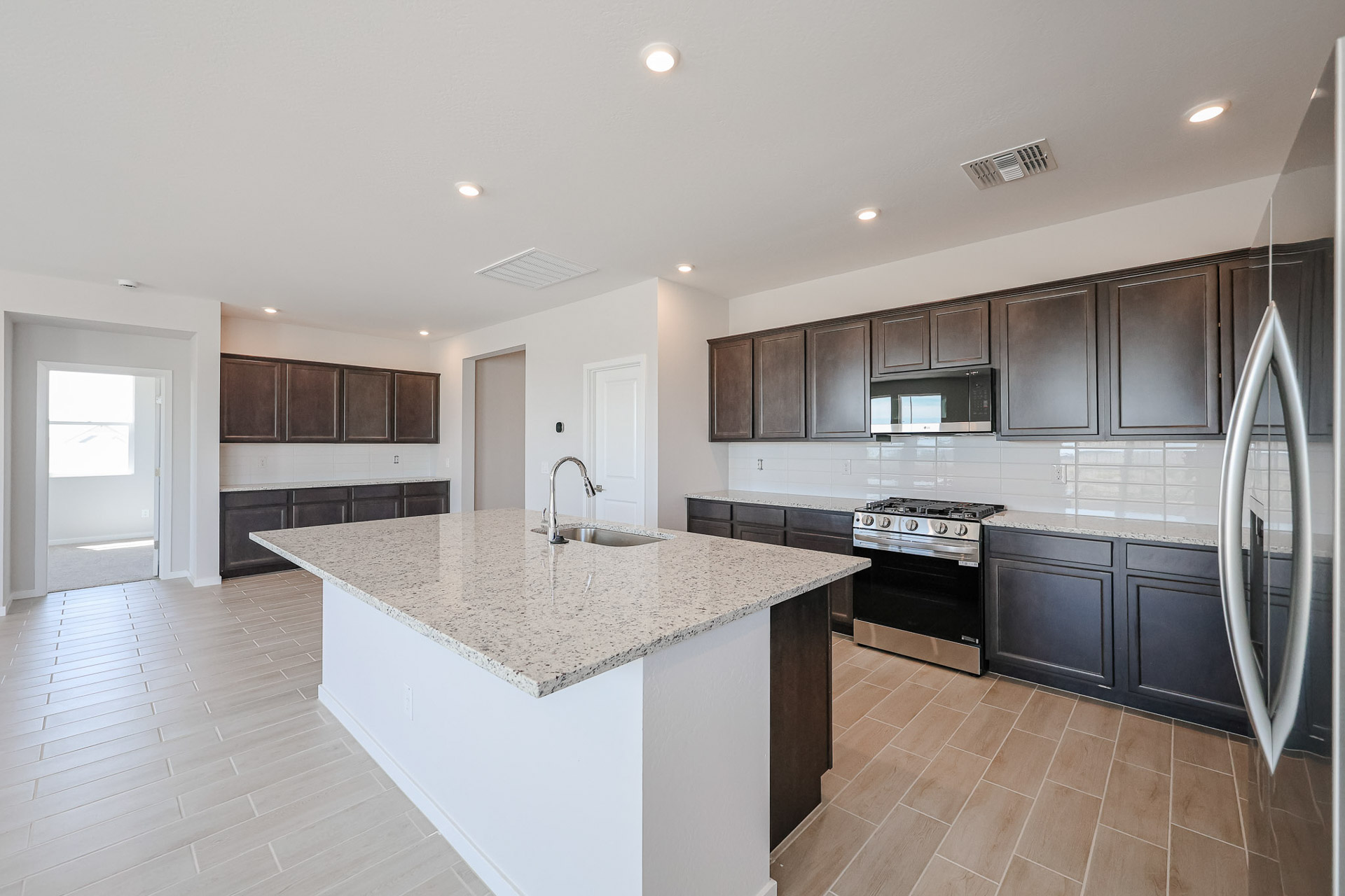 A kitchen with black cabinets.