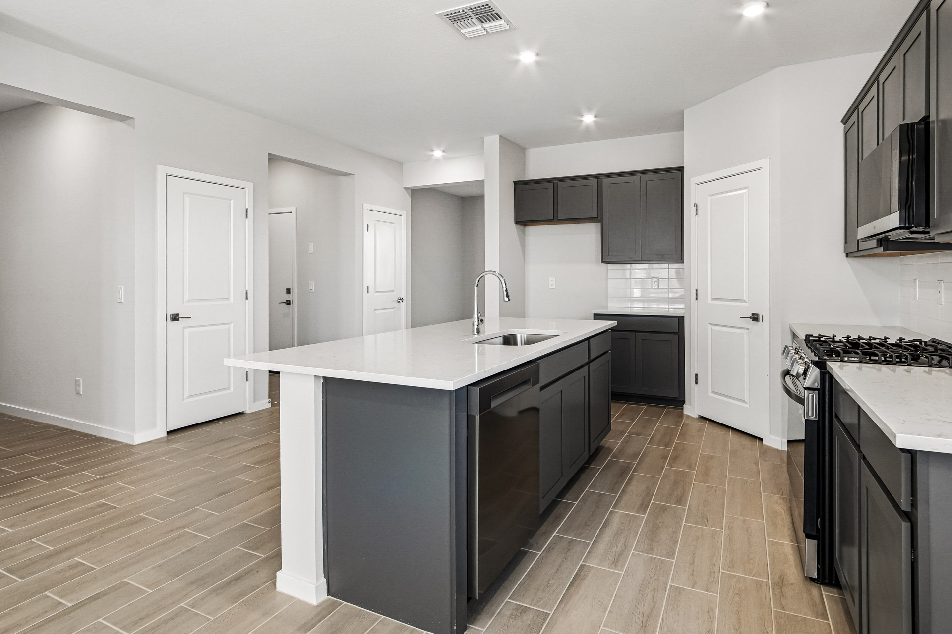 A kitchen with black cabinets.