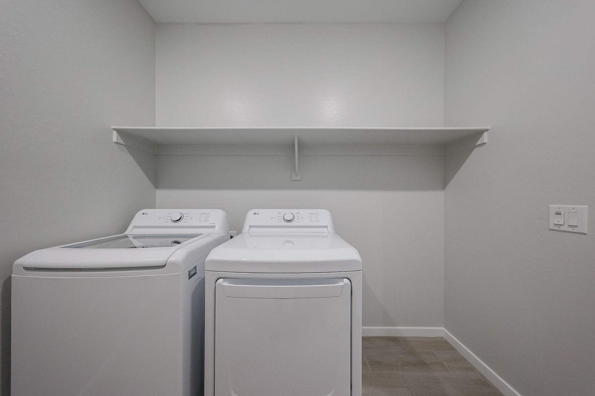 A washing machine and dryer in a room.