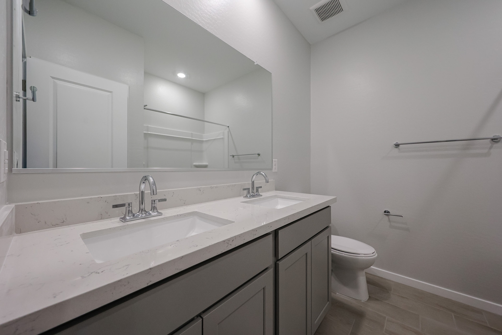 A bathroom with a sink and a toilet.