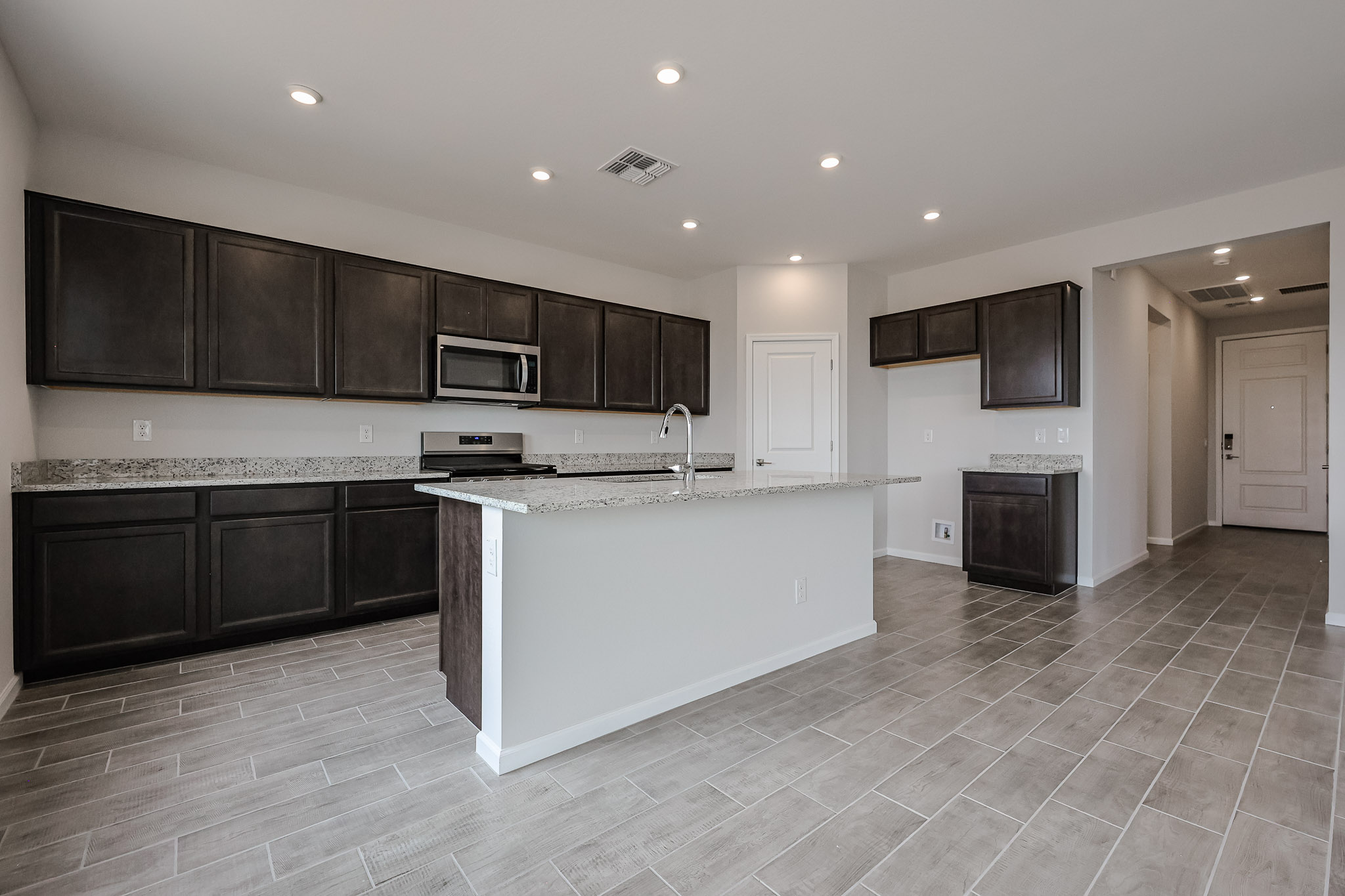 A kitchen with black cabinets.