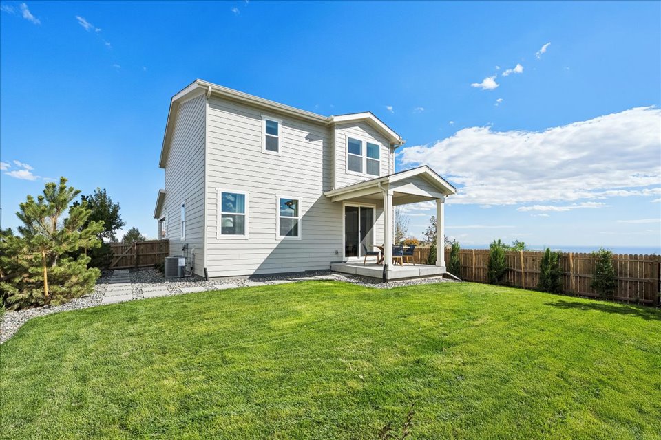 A house with a fence and grass.