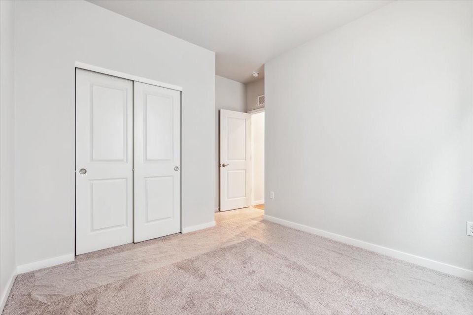 A hallway with white doors.