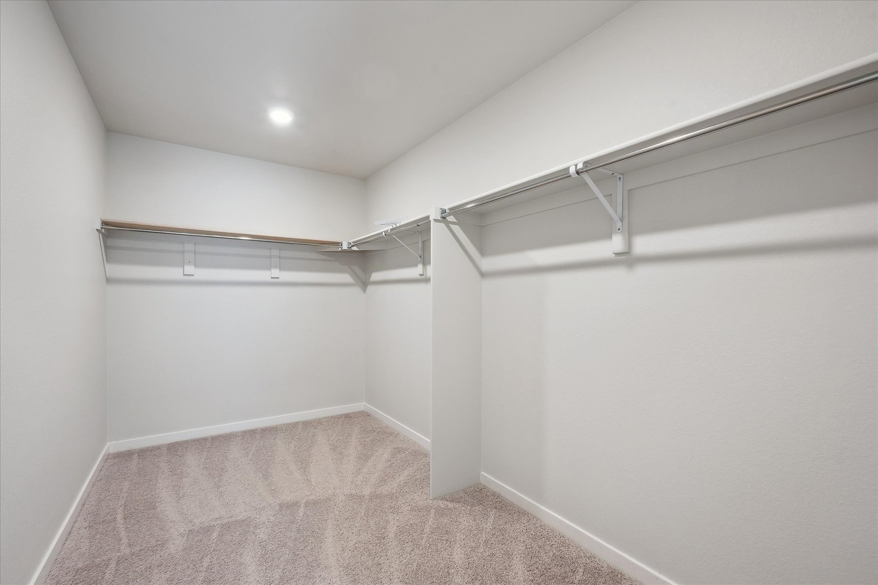 A white room with a metal railing.