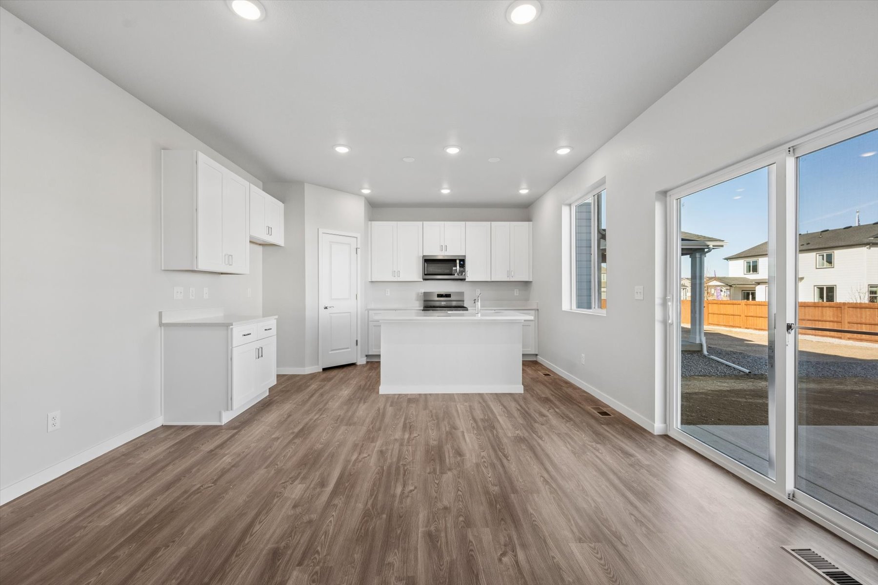 A kitchen with white cabinets.