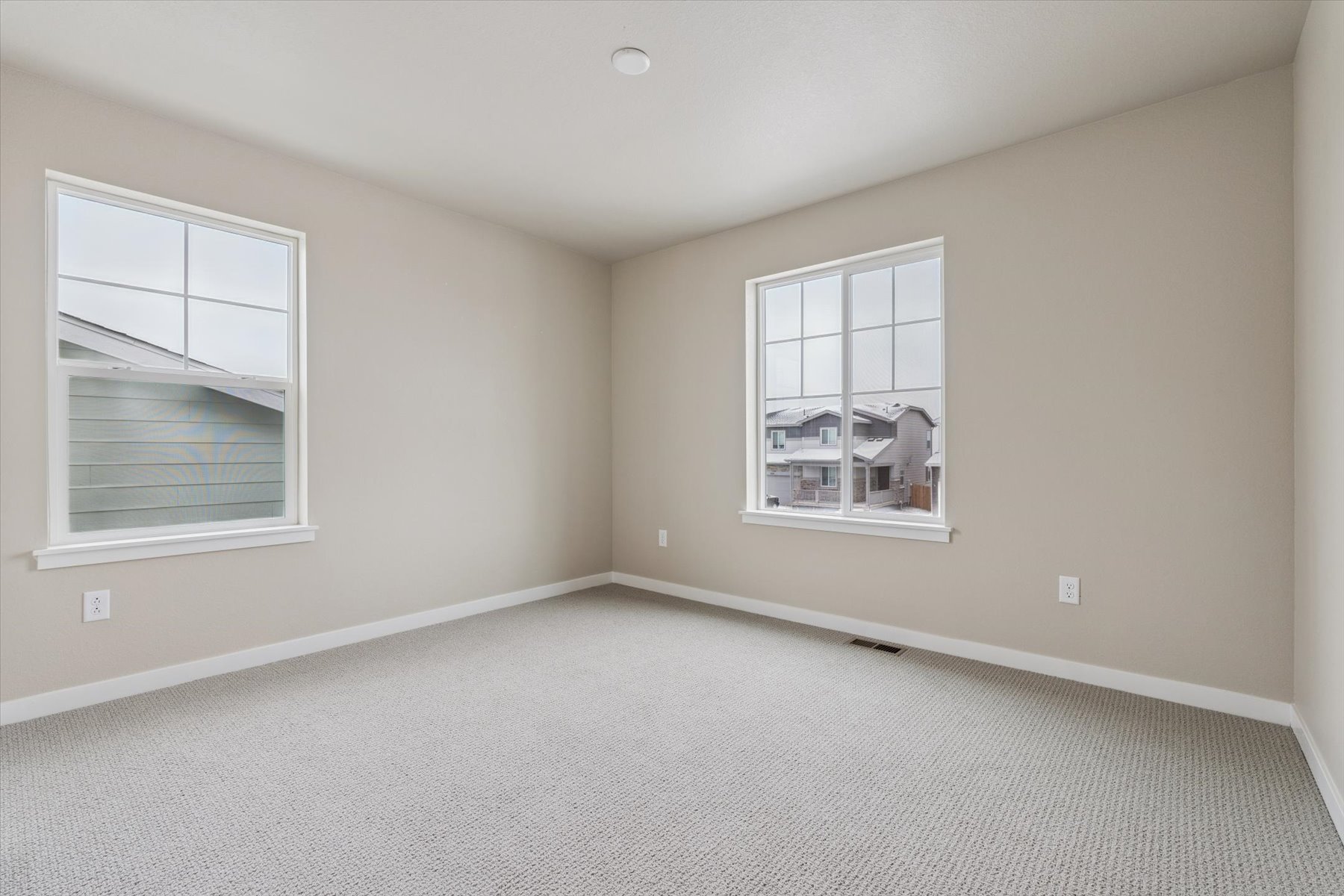 A room with a window and a carpet.
