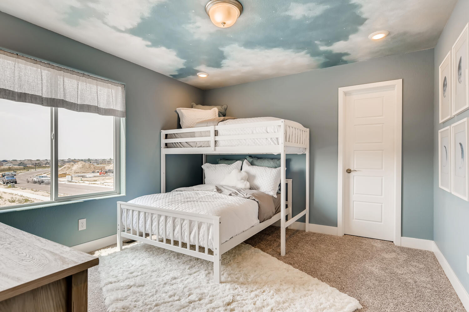 A bedroom with a bed and a window.