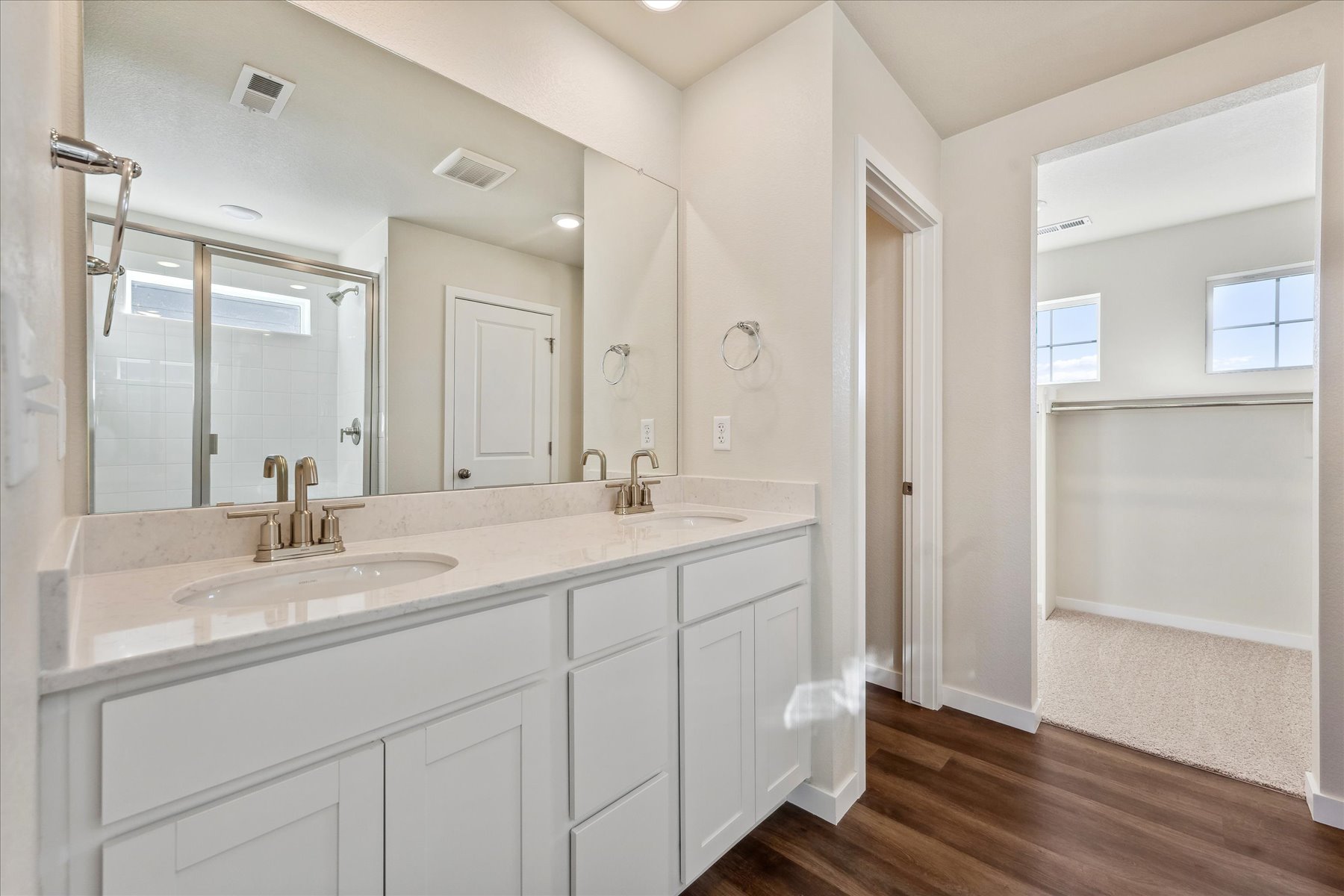 A bathroom with a large mirror.