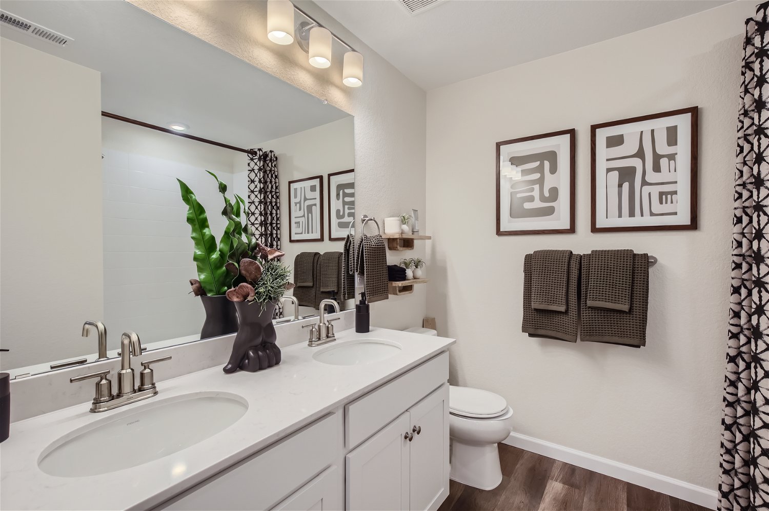 A bathroom with a large mirror.