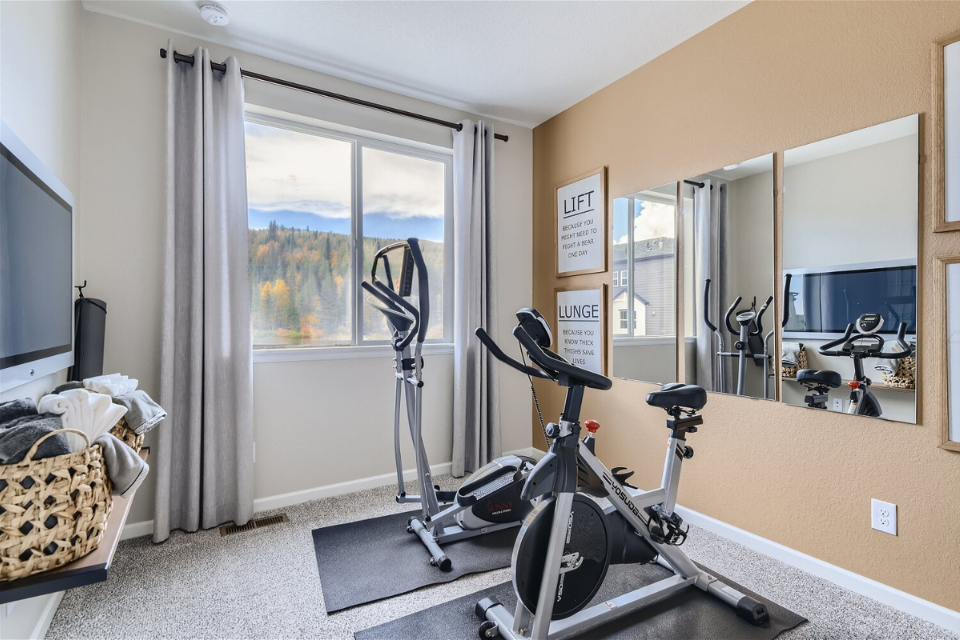 A room with a bike and a window.