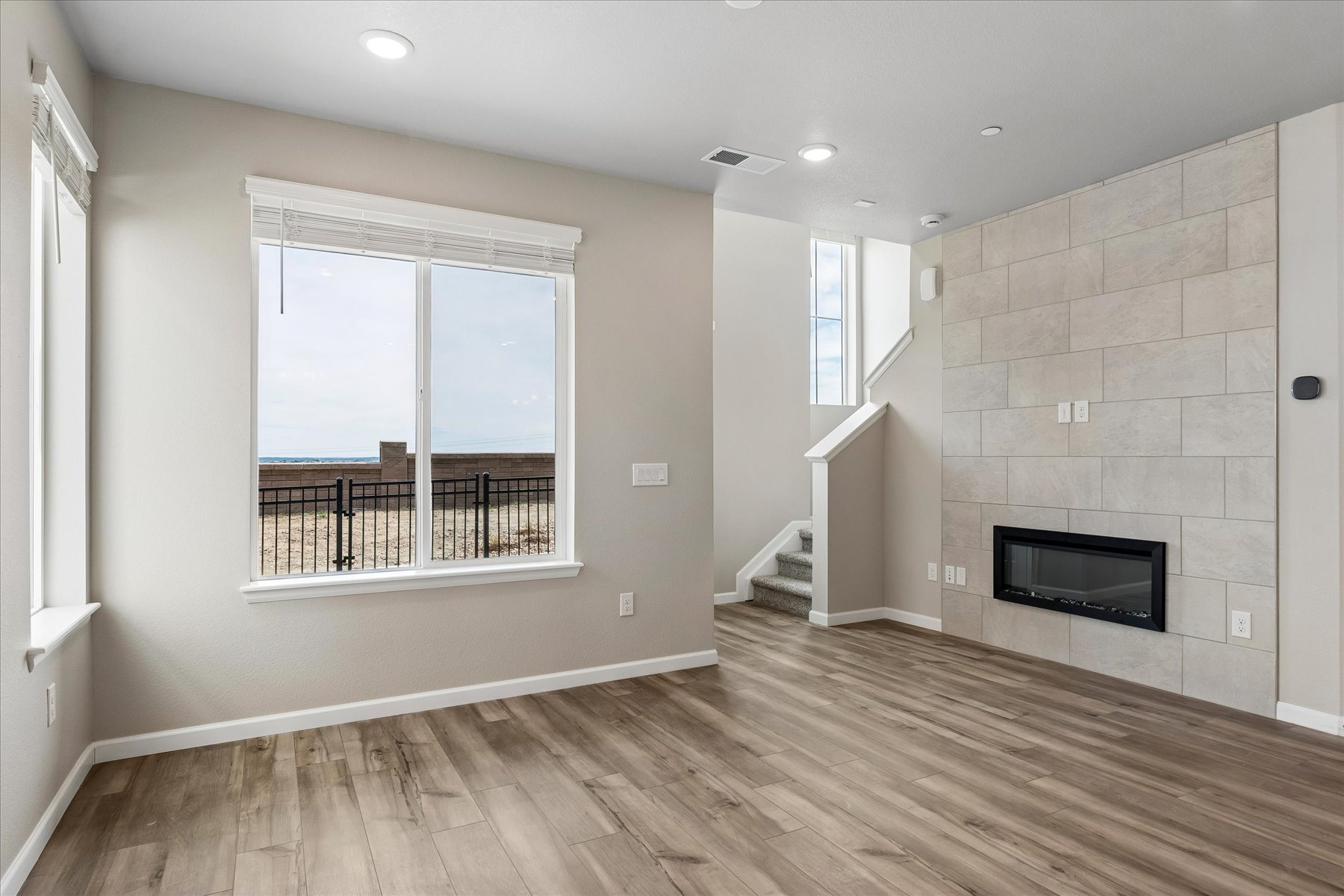 A room with a fireplace and a wood floor.