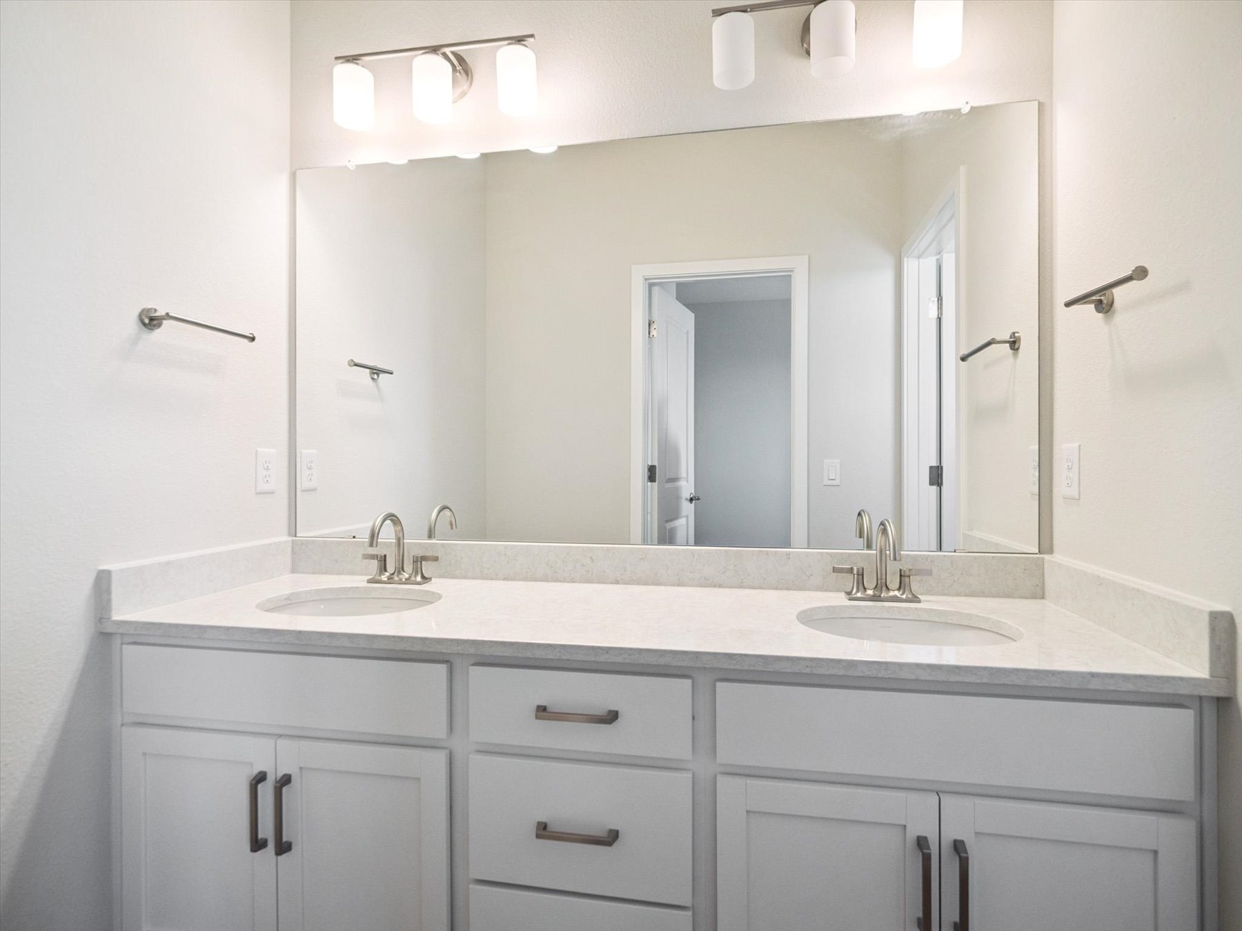 A bathroom with a large mirror.