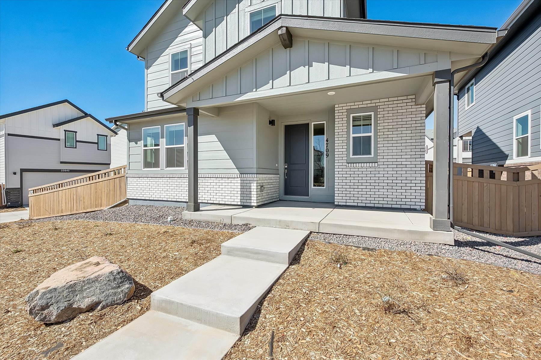 A house with a fence and dirt.