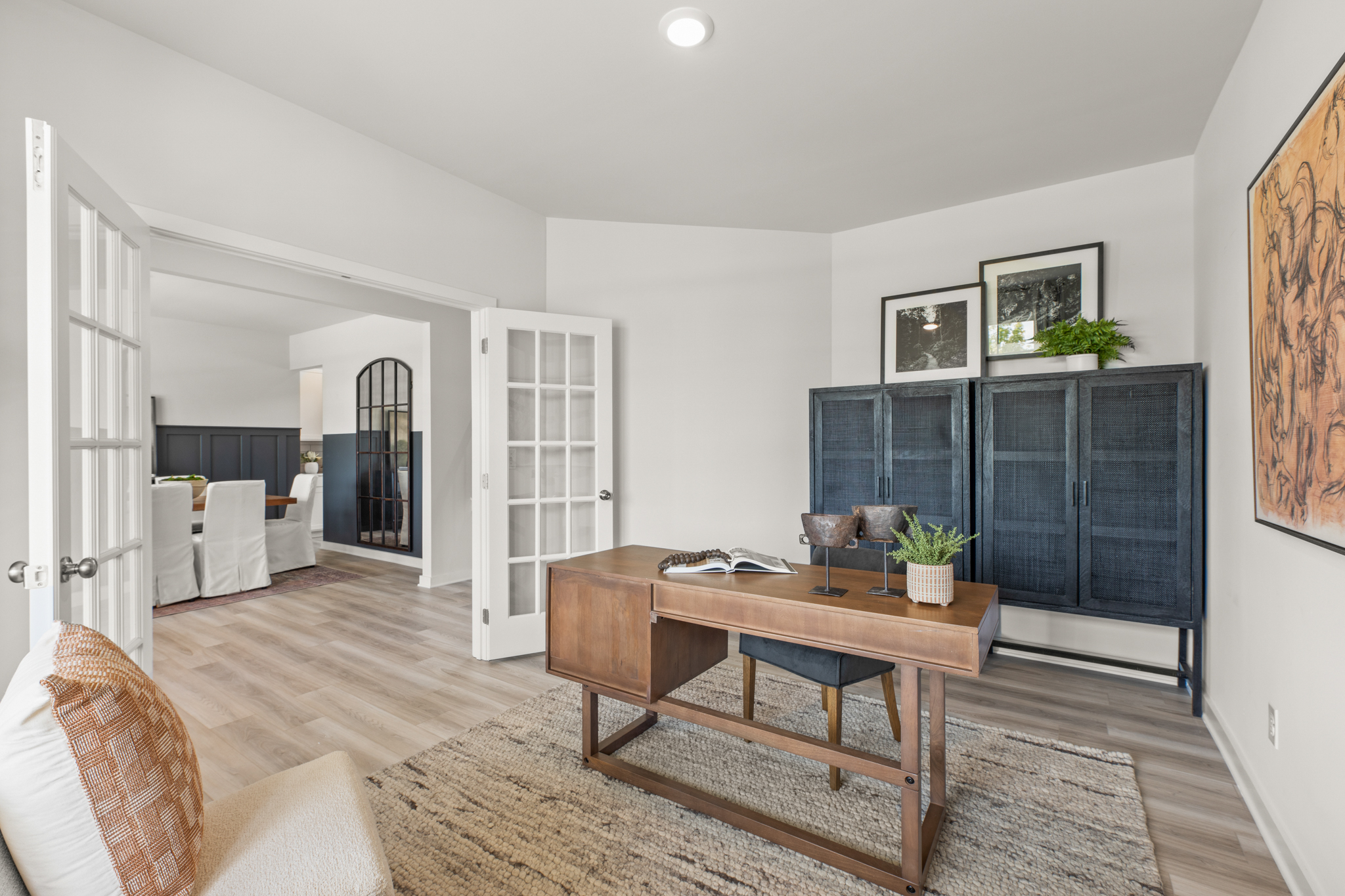A living room with a table and chairs.