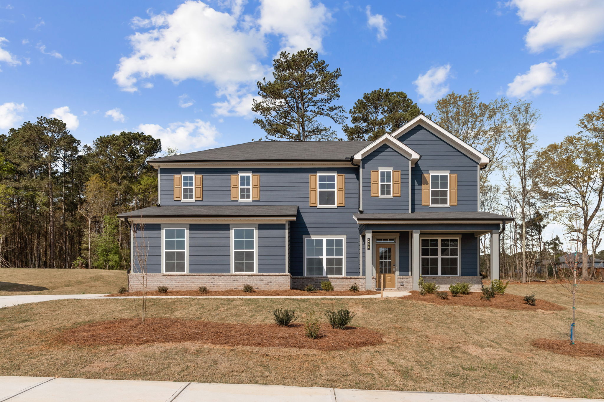 A house with trees in the back.