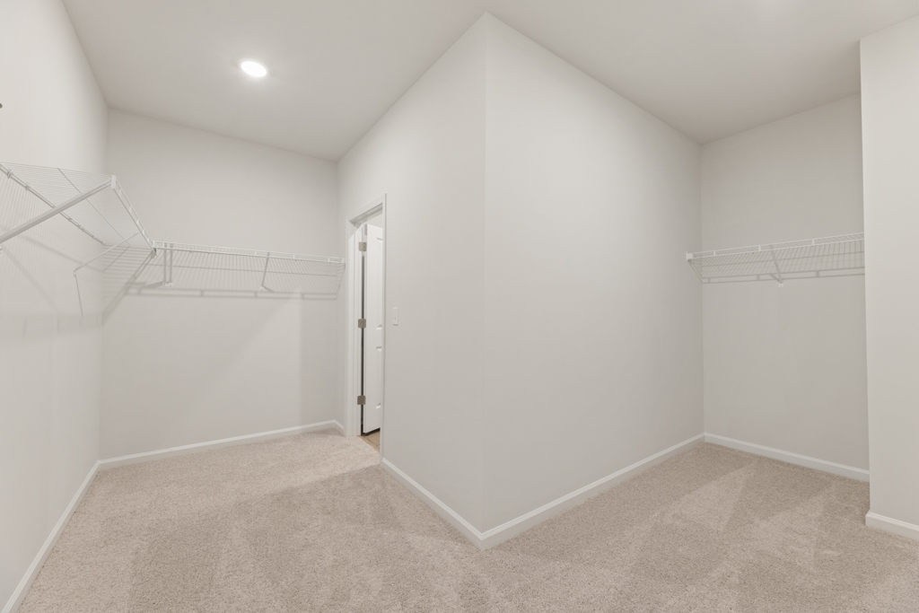 A white hallway with a staircase.