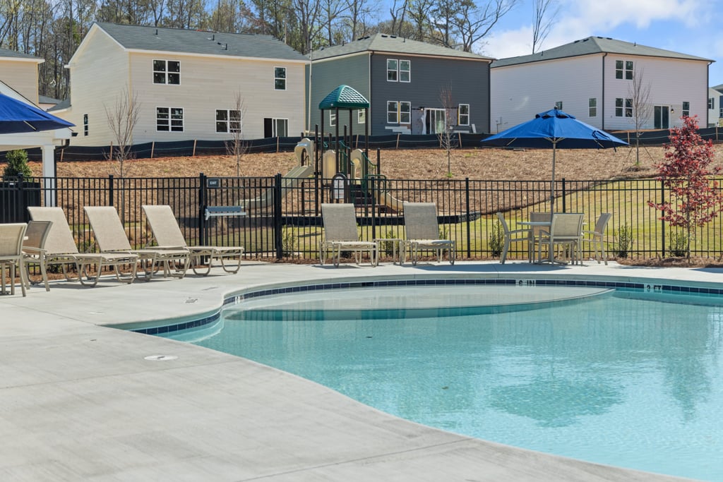 A pool with chairs around it.
