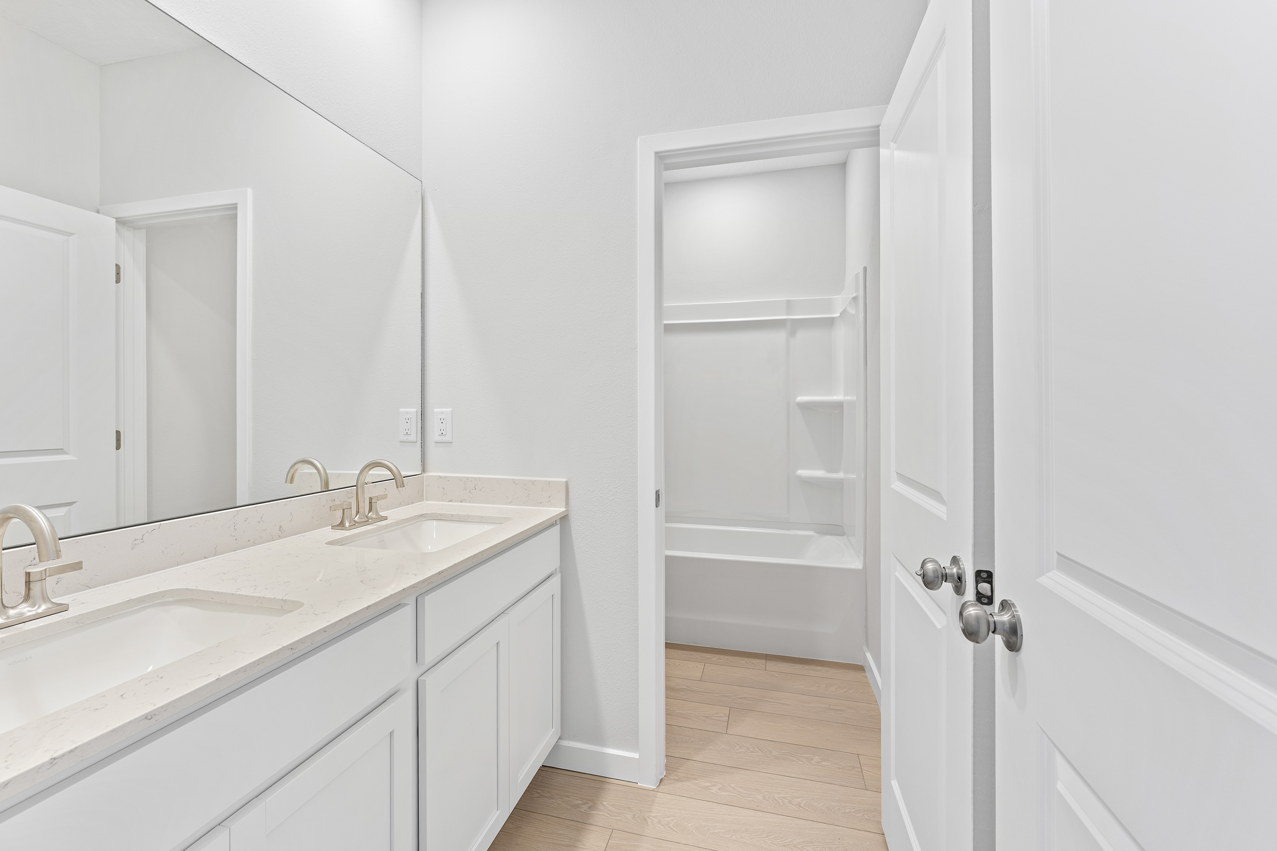 Lot 20 Ponderosa II Guest Bathroom with Double Vanity Sink and Tub Shower Combo at Camden Woods in Kingsland, GA