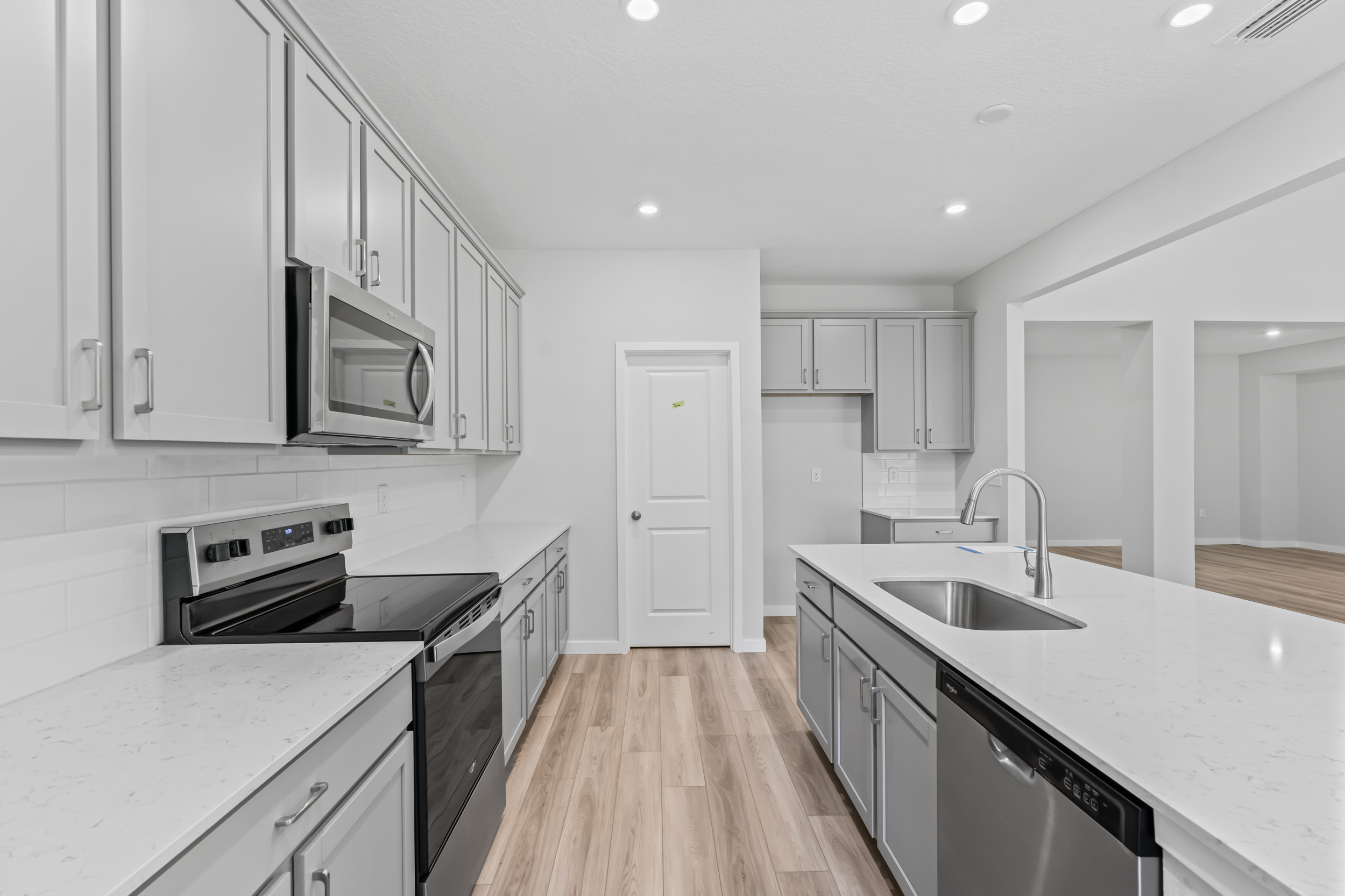 River Birch Lot 587 Kitchen with Light Gray Cabinets at NorthShore in Kingsland